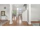 Open hallway with hardwood floors, showcasing the home's inviting layout and abundant natural light at 2070 Mustang Chase Dr, Carmel, IN 46074