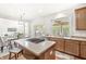 View of kitchen features stainless appliances, island with cooktop, and eat-in area and opens to living room at 2070 Mustang Chase Dr, Carmel, IN 46074