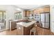 Bright kitchen features stainless appliances, kitchen island with gas cooktop, and access to a sunny breakfast nook at 2070 Mustang Chase Dr, Carmel, IN 46074