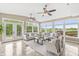 Bright sunroom boasts abundant natural light, comfortable seating, and scenic backyard views at 2070 Mustang Chase Dr, Carmel, IN 46074