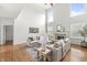 Large living room with hardwood floors, vaulted ceiling, and a cozy fireplace at 2070 Mustang Chase Dr, Carmel, IN 46074