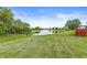 Scenic pond view with lush green landscape and blue sky, offering a serene and natural backdrop to the community at 2070 Mustang Chase Dr, Carmel, IN 46074