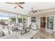 Bright sunroom featuring tiled flooring, ceiling fans, and large windows with backyard views at 2070 Mustang Chase Dr, Carmel, IN 46074