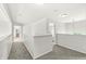 Upstairs hallway with neutral walls and carpet leading to bedrooms and a bathroom at 2070 Mustang Chase Dr, Carmel, IN 46074