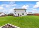 Spacious backyard featuring a brick firepit, outdoor seating, and a well-manicured lawn at 2337 Hanover Rd, Brownsburg, IN 46112