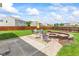 Inviting backyard featuring a brick firepit, patio, colorful outdoor seating, and a lush lawn at 2337 Hanover Rd, Brownsburg, IN 46112