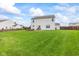 Wide backyard with outdoor seating and firepit, providing ample space for recreation and relaxation at 2337 Hanover Rd, Brownsburg, IN 46112