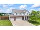 Charming two-story home boasts a brick facade, attached two-car garage, and manicured lawn at 2337 Hanover Rd, Brownsburg, IN 46112