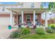 Inviting front porch featuring brick accents, stylish decor, and manicured landscaping at 2337 Hanover Rd, Brownsburg, IN 46112