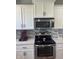 Close-up of a modern kitchen with stainless steel microwave and range, plus stylish backsplash at 2337 Hanover Rd, Brownsburg, IN 46112