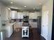 Open kitchen layout with island, stainless steel appliances, and dark hardwood floors at 2337 Hanover Rd, Brownsburg, IN 46112