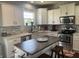 Bright kitchen featuring white cabinetry, stainless steel appliances, and a charming kitchen island at 2337 Hanover Rd, Brownsburg, IN 46112