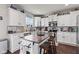 Bright kitchen featuring an island with seating, white cabinetry, and modern appliances at 2337 Hanover Rd, Brownsburg, IN 46112