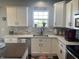 Well-lit kitchen with white cabinets, modern countertops, and a view from the window at 2337 Hanover Rd, Brownsburg, IN 46112