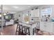 Open kitchen featuring an island with seating, ample cabinet space, and a view of the living room at 2337 Hanover Rd, Brownsburg, IN 46112