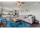 Spacious living room featuring a large sectional sofa, hardwood floors, and an open layout to the kitchen at 2337 Hanover Rd, Brownsburg, IN 46112