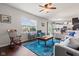 Bright living room featuring a ceiling fan, large window, and an eye-catching blue rug at 2337 Hanover Rd, Brownsburg, IN 46112