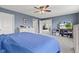 A primary bedroom features a blue accent wall, a fan and modern furniture at 2337 Hanover Rd, Brownsburg, IN 46112
