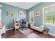 Bright home office with dual windows, a comfortable desk setup, and a cozy seating area at 2337 Hanover Rd, Brownsburg, IN 46112