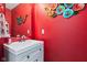 This powder room features vibrant red walls and a modern sink at 2337 Hanover Rd, Brownsburg, IN 46112