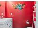 A vibrant powder room features red walls and a stylish vanity at 2337 Hanover Rd, Brownsburg, IN 46112