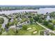 An aerial view shows lakeside homes, tennis courts, and docks along the water at 241 Chamberlain Cir, Noblesville, IN 46062