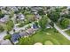 An aerial view shows houses in a residential neighborhood next to a golf course at 241 Chamberlain Cir, Noblesville, IN 46062