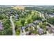 An aerial view shows homes in a neighborhood next to a golf course and near a body of water at 241 Chamberlain Cir, Noblesville, IN 46062