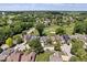 An aerial view shows a residential neighborhood with mature trees, a golf course, and a pond at 241 Chamberlain Cir, Noblesville, IN 46062