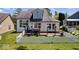 Charming white house featuring a cozy backyard with string lights and a decorative picket fence at 241 Chamberlain Cir, Noblesville, IN 46062
