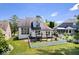 Beautiful backyard view with a well-manicured lawn and a charming white picket fence at 241 Chamberlain Cir, Noblesville, IN 46062