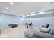Finished basement with neutral carpeting, gray sectional couch, and a full drum set at 241 Chamberlain Cir, Noblesville, IN 46062