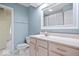 A bathroom featuring a white sink vanity, framed mirror, and soft blue accent walls at 241 Chamberlain Cir, Noblesville, IN 46062