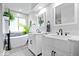 Bright bathroom featuring double sinks, modern fixtures, a garden tub and natural light at 241 Chamberlain Cir, Noblesville, IN 46062