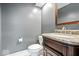 Stylish half bathroom featuring a granite vanity top, gray walls, and modern fixtures at 241 Chamberlain Cir, Noblesville, IN 46062