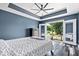This primary bedroom features a ceiling fan, hardwood floors and an attached outdoor deck at 241 Chamberlain Cir, Noblesville, IN 46062