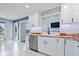 Well-lit kitchen with stainless steel appliances, white cabinets, butcher block countertops, and tile flooring at 241 Chamberlain Cir, Noblesville, IN 46062