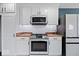 Updated kitchen with stainless steel oven, microwave, and white cabinets, offering a modern cooking space at 241 Chamberlain Cir, Noblesville, IN 46062