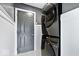 Laundry room featuring gray walls and white wainscoting and a stacked washer dryer at 241 Chamberlain Cir, Noblesville, IN 46062