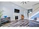Open living room with a fireplace, TV, and hardwood floors, perfect for relaxation and entertainment at 241 Chamberlain Cir, Noblesville, IN 46062