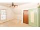 Attic bedroom with ceiling fan, carpeting, closets, and lots of light from the window, a perfect space for relaxing at 31 E Mill St, New Palestine, IN 46163