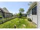 Cozy backyard with a well-maintained lawn, a charming picket fence, a shade tree, and a peaceful outdoor setting at 31 E Mill St, New Palestine, IN 46163