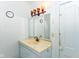Bathroom featuring a stylish vanity with a mirror, orange light fixture, and ample lighting for getting ready at 31 E Mill St, New Palestine, IN 46163