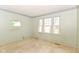 Light-filled bedroom featuring windows and neutral green walls at 31 E Mill St, New Palestine, IN 46163