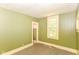 Cozy bedroom featuring beadboard walls and a bright window, offering serene natural light at 31 E Mill St, New Palestine, IN 46163
