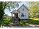 Charming two-story home with a covered porch and landscaped front yard, perfect for enjoying quiet mornings at 31 E Mill St, New Palestine, IN 46163