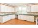 Bright kitchen with white cabinets, laminate countertop, and double sink at 31 E Mill St, New Palestine, IN 46163