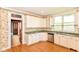 Traditional kitchen with ample cabinetry, laminate counters, and a double sink at 31 E Mill St, New Palestine, IN 46163