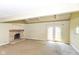 Living room featuring a brick fireplace, french doors and plenty of natural light at 31 E Mill St, New Palestine, IN 46163