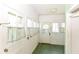 Bright sunroom featuring white walls and multiple windows, perfect for relaxation at 31 E Mill St, New Palestine, IN 46163